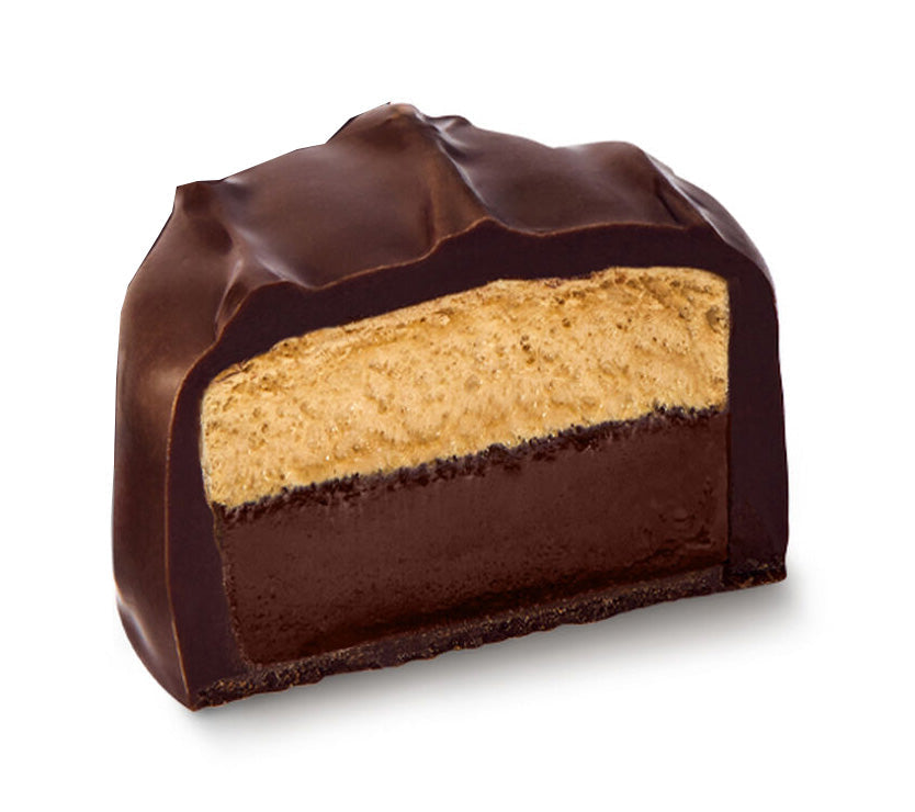 See's dark coffee scotchmallow cut showing caramel and marshmallow center on a white background