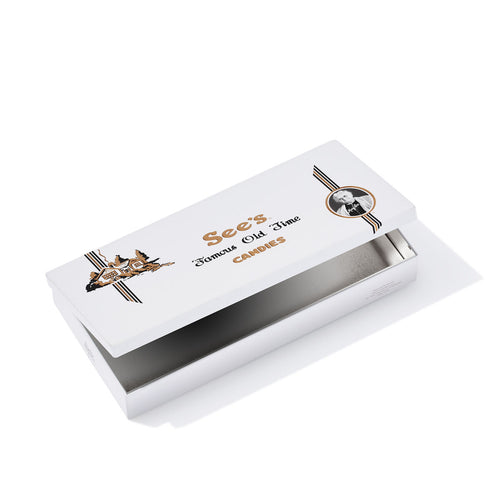 White candy tin with gold text and See's Candies logo on a white background