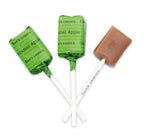 Two caramel apple-flavored lollipops with green wrappers on a white background