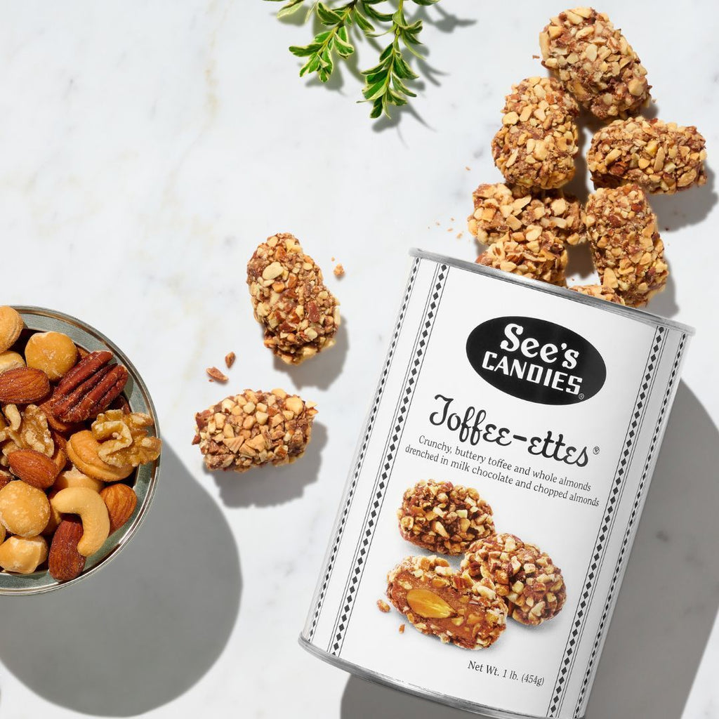 See's Candies Toffee-ettes with a bowl of nuts on a light background