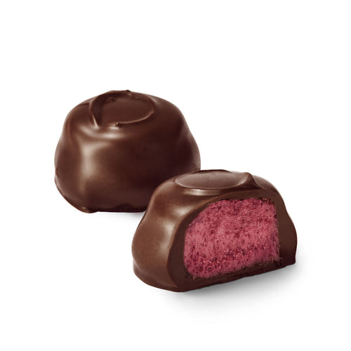 Chocolate soft centres with a red raspberry centre on a white background