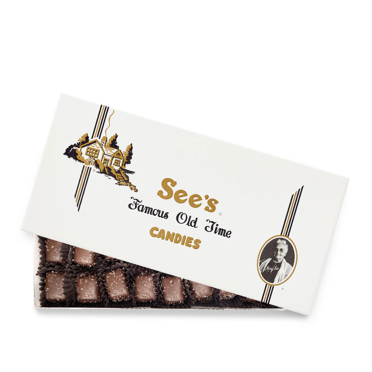An open box of See's Famous Old Time Candies, showing several dark salted caramels inside a white cardboard packaging with gold and black lettering.