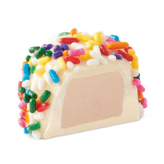 sees birthday cake white chocolate piece cut in half on white background