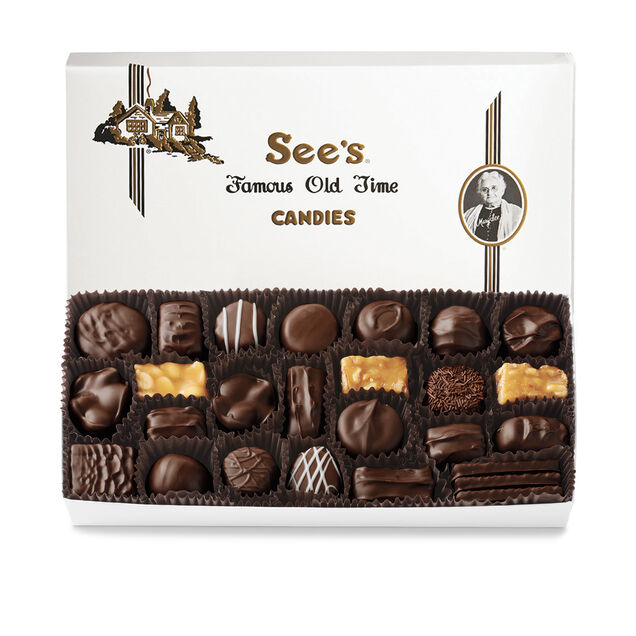 Box of See's Candies with a variety of dark chocolates on a white background