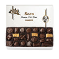Box of See's Candies with a variety of dark chocolates on a white background