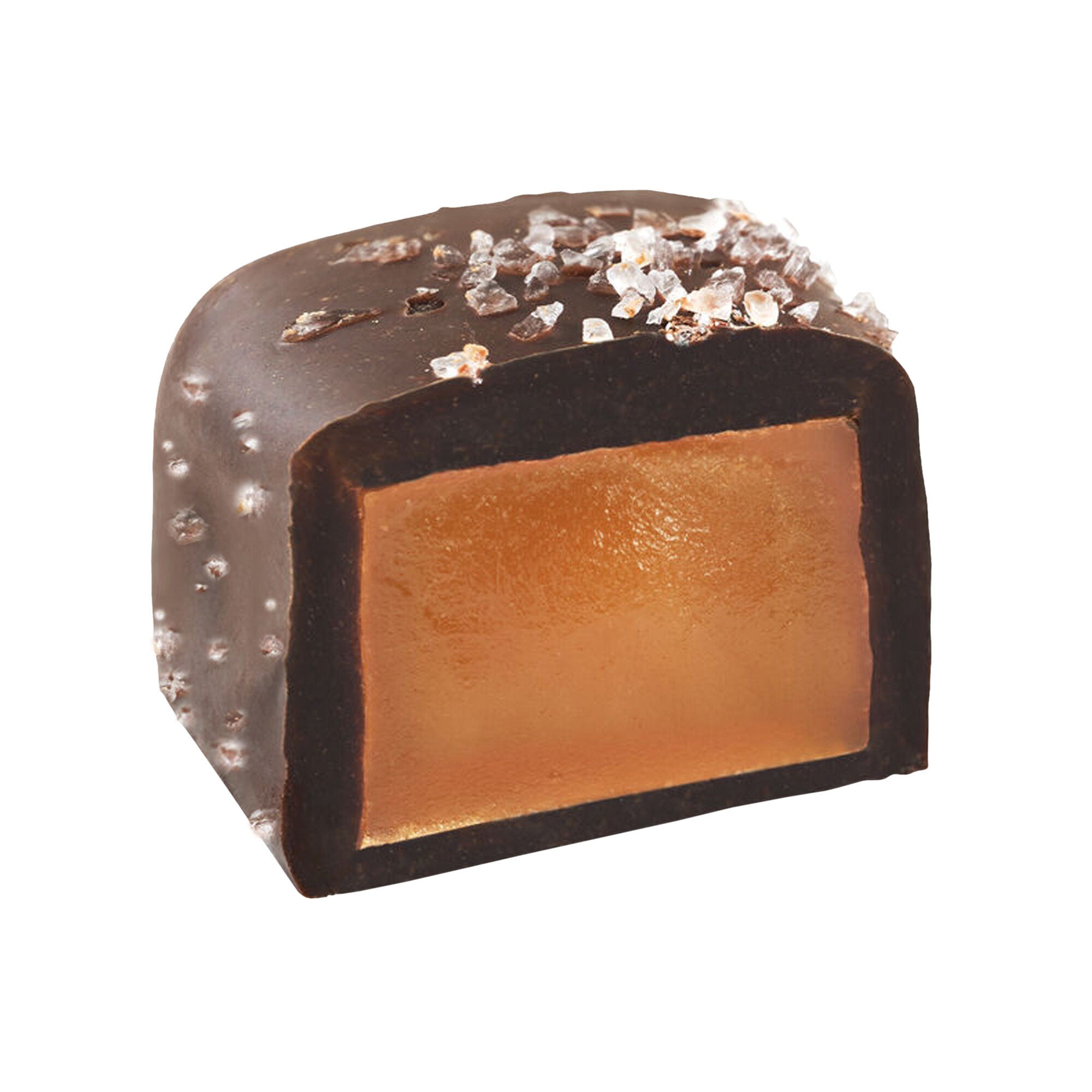 Chocolate-covered dessert with a gold caramel center with sea salt sprinked on top on a white background