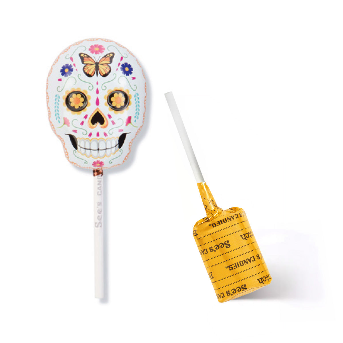 A sugar skull lollipop tin shown on a white background, with one lollipop upright displaying the decorated skull design and the other lying on its side showing the yellow butterscotch lollypop with wrapper with 'See's Candies' text.