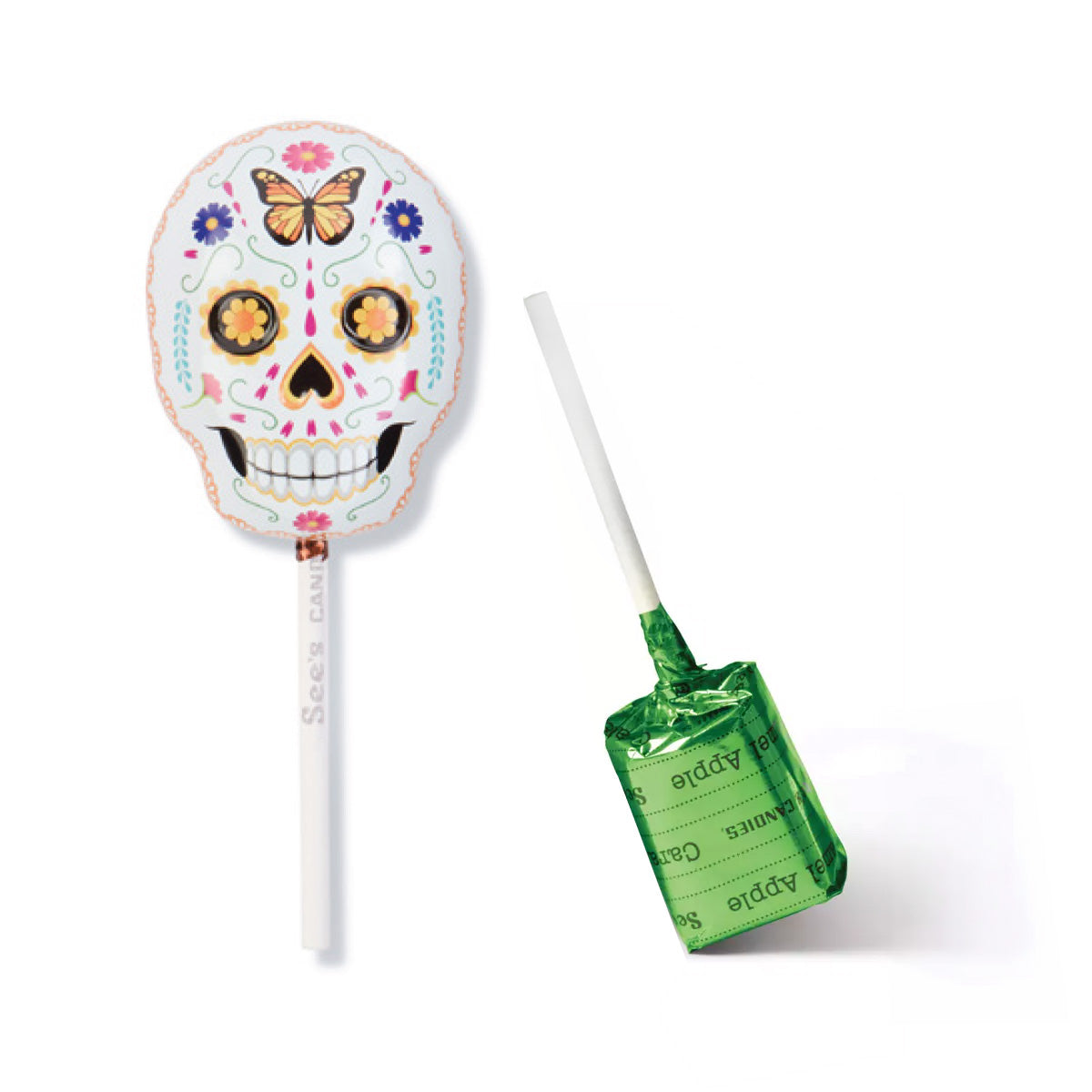 A sugar skull lollipop tin shown on a white background, with one lollipop upright displaying the decorated skull design and the other lying on its side showing the green candy apple lollypop with wrapper with 'See's Candies' text.