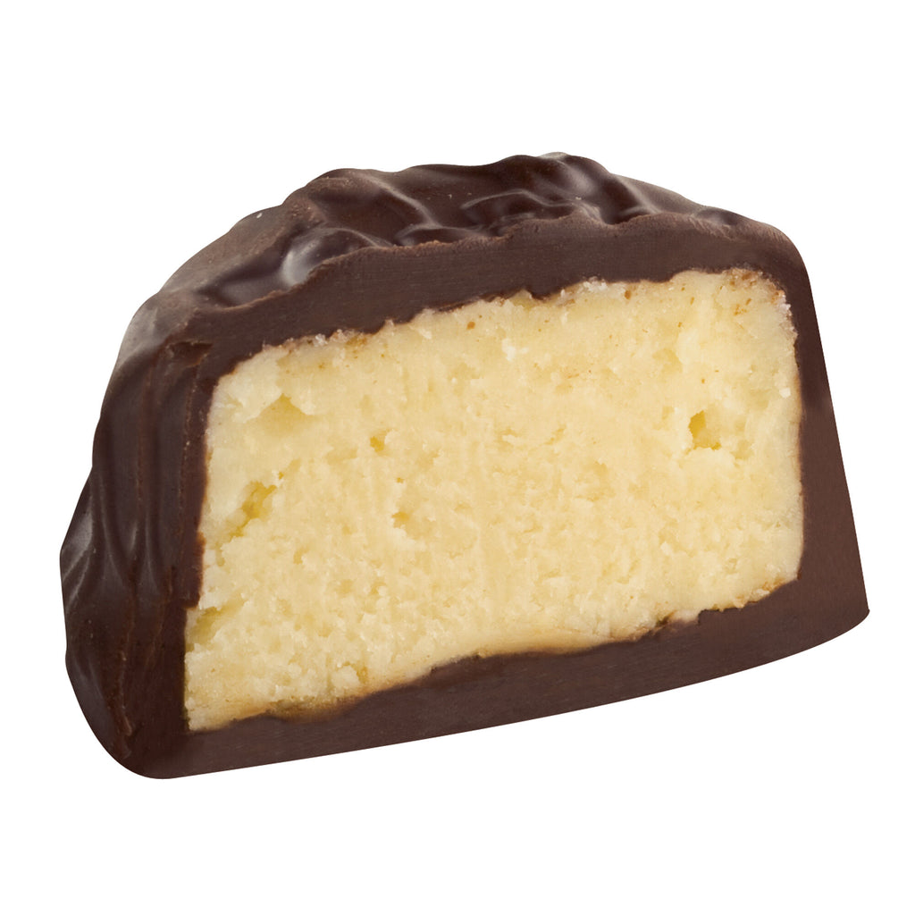Dark chocolate-covered pineapple truffle with a creamy filling on a white background