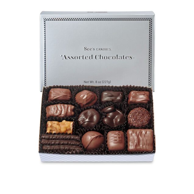 Box of assorted chocolates with See's Candies branding on a white background