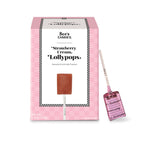 Pink packaging of See's Candies Strawberry Cream Lollypops with a lollipop inside.