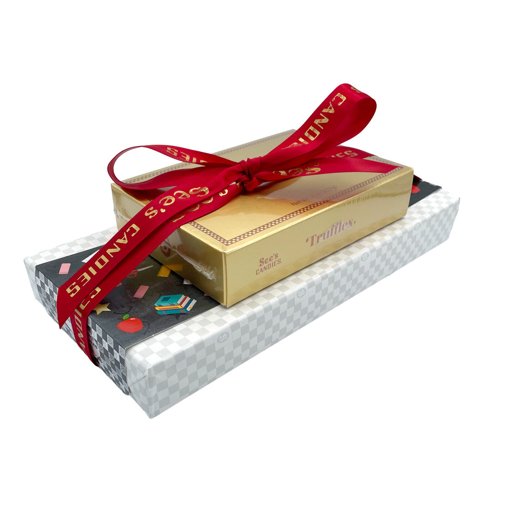 Gold chocolate box with red ribbon and 'Candies' text on a white background