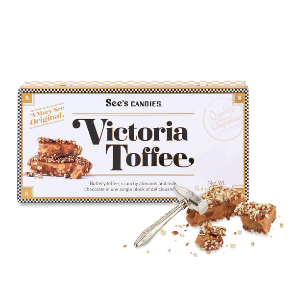 Box of See's Candies Victoria Toffee with toffee pieces and a knife on a white background
